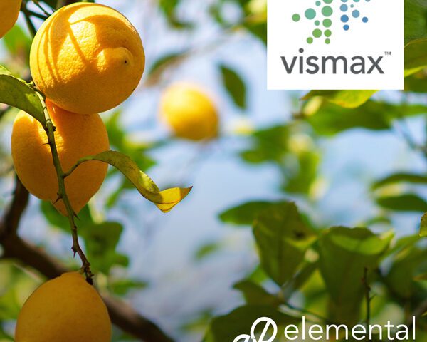 A citrus tree with ripe yellow fruit under a bright blue sky, featuring the Vismax™ and Elemental Enzymes® logos, highlighting agricultural innovation.